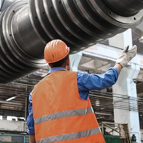 Man directing building materials overhead.