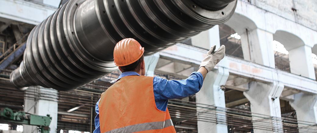 Man directing building materials overhead.